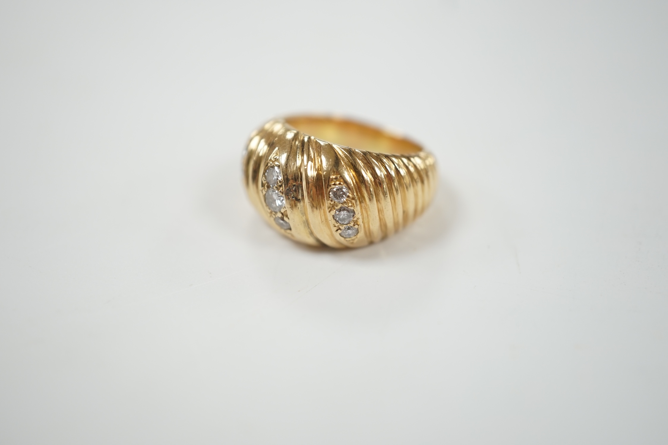 A fluted yellow metal and three row, nine stone diamond set dress ring, size H, gross weight 16 grams.